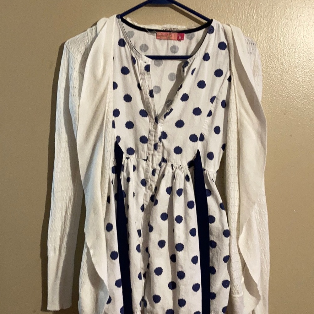 A white cardigan with polka dot navy blow pattern